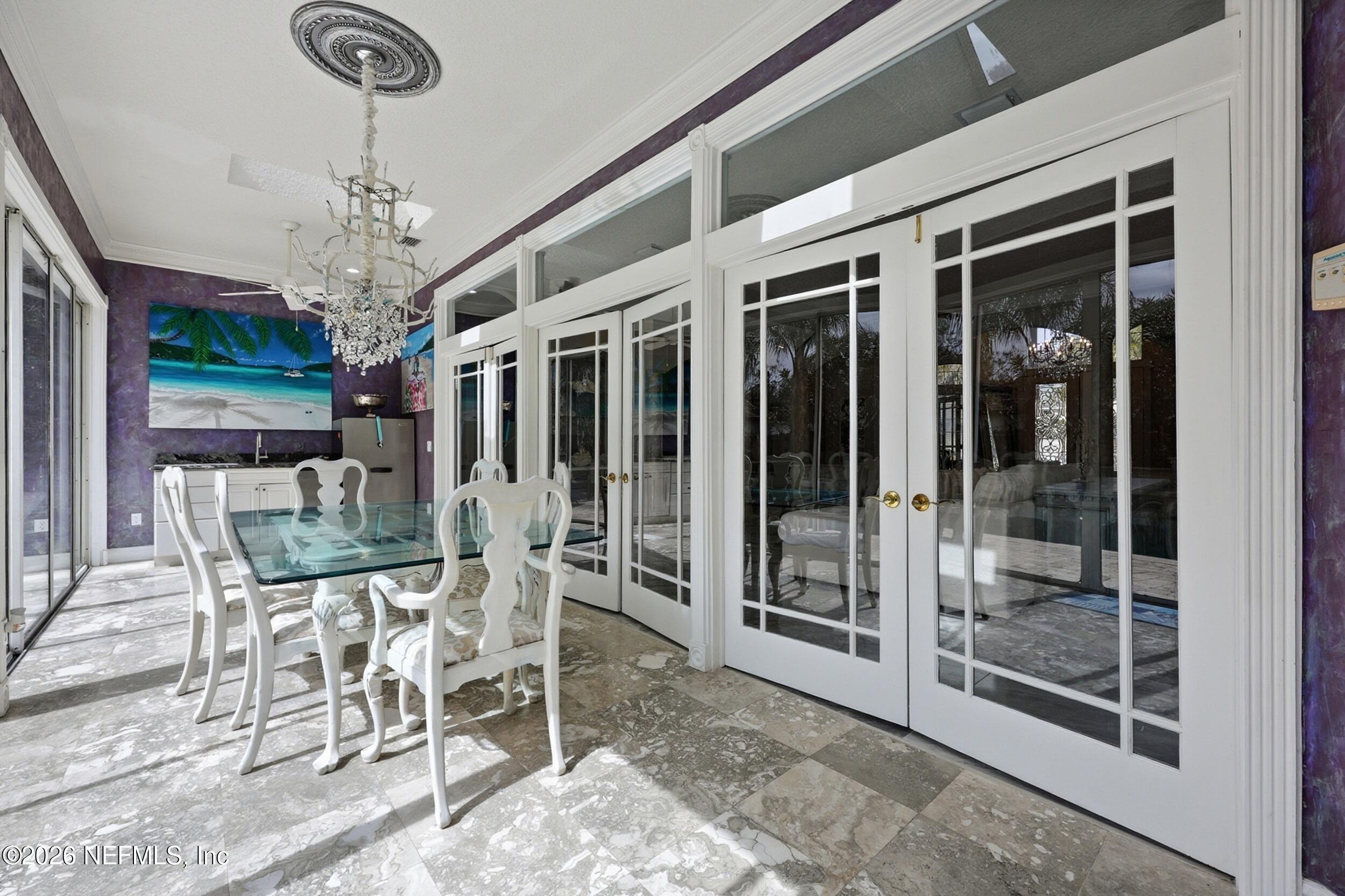40 Tallwood Road Jacksonville Beach, FL 32250 - Photo 26 of 75 a view of a dining room with furniture chandelier and glass door