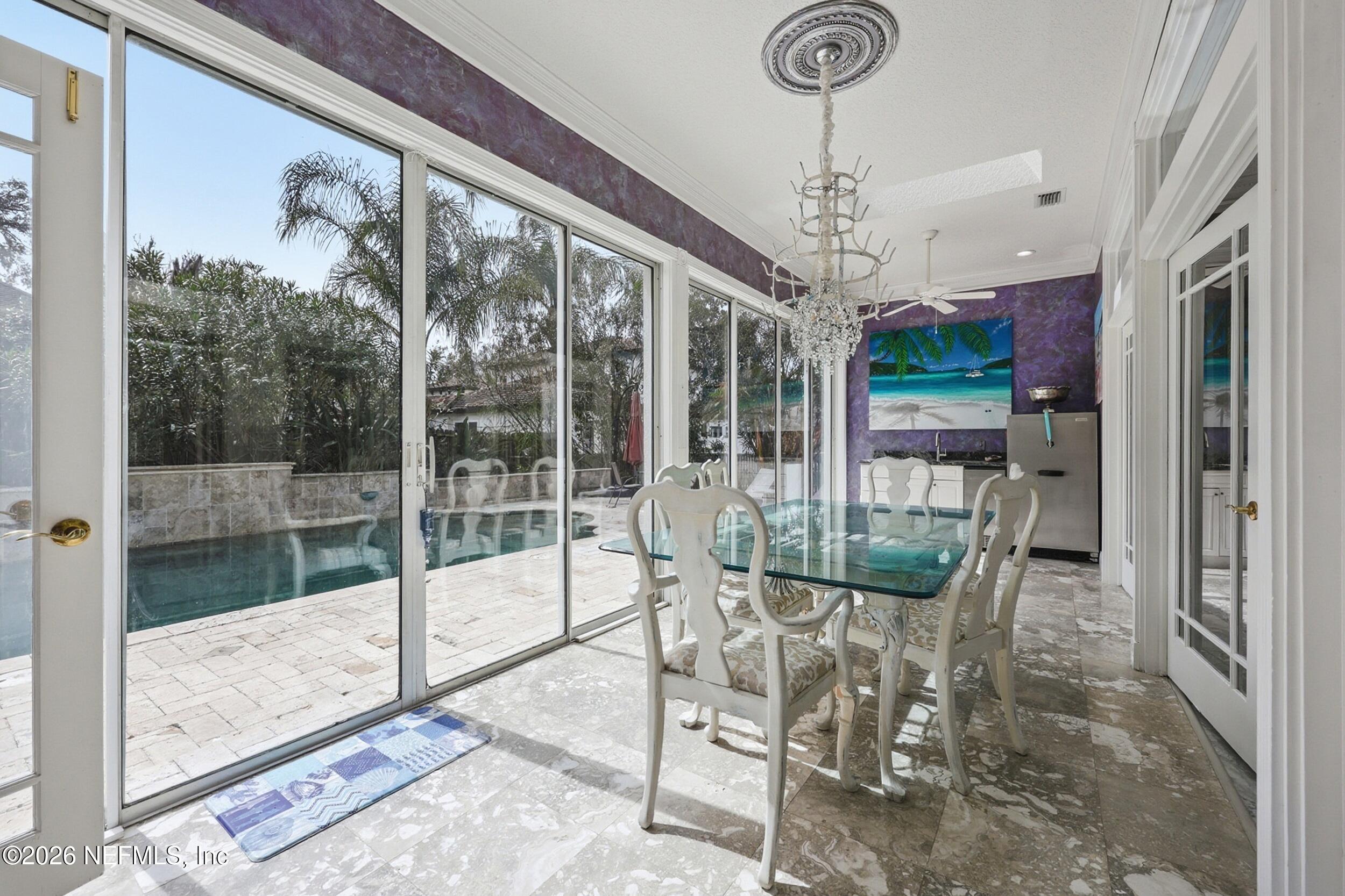 40 Tallwood Road Jacksonville Beach, FL 32250 - Photo 27 of 75 a dining room with furniture a chandelier and glass door