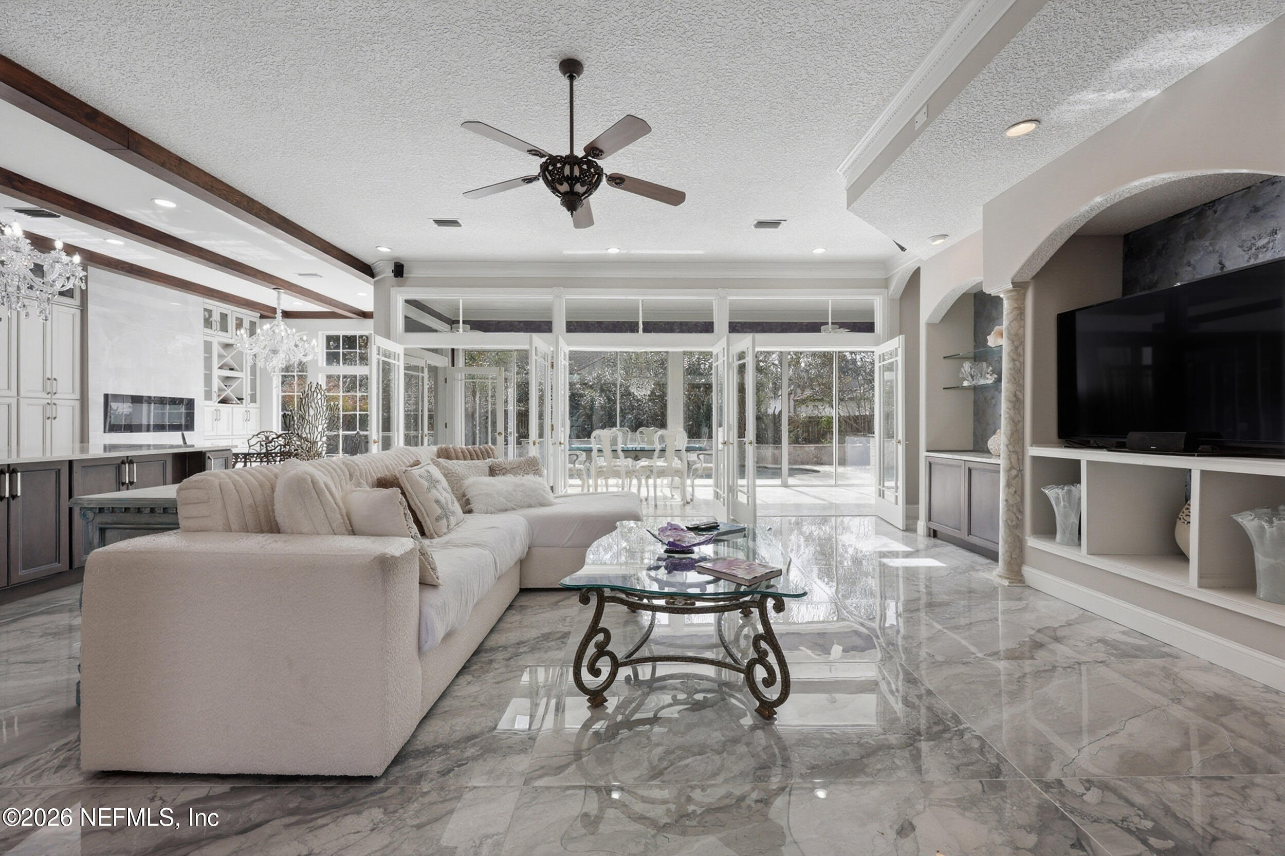 40 Tallwood Road Jacksonville Beach, FL 32250 - Photo 28 of 75 a living room with furniture a flat screen tv and a large window
