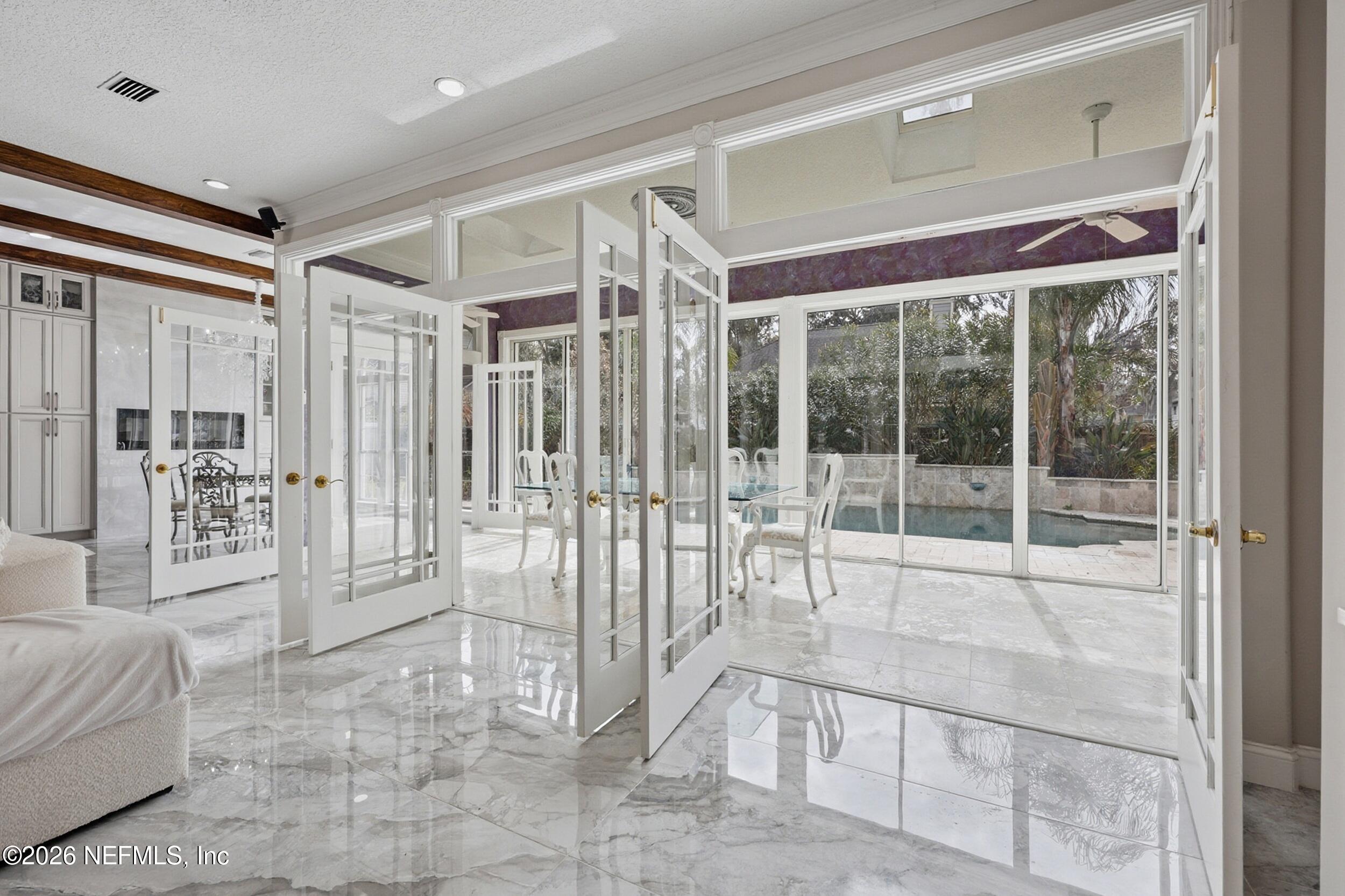 40 Tallwood Road Jacksonville Beach, FL 32250 - Photo 29 of 75 a room with lots of white furniture and floor to ceiling windows