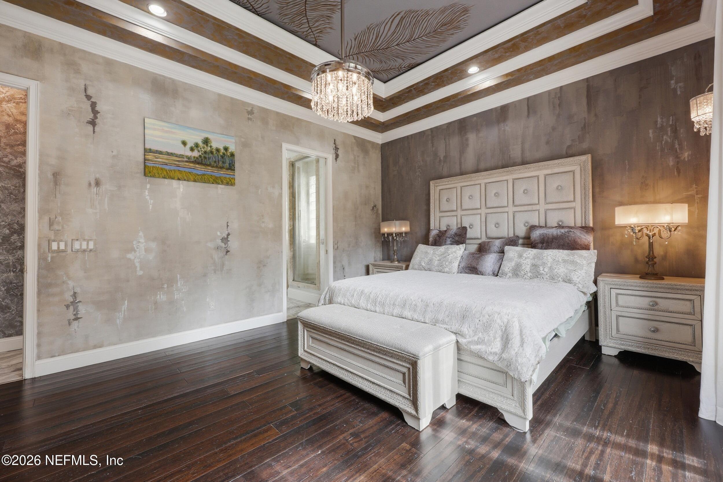 40 Tallwood Road Jacksonville Beach, FL 32250 - Photo 35 of 75 a spacious bedroom with a bed and a wooden floor