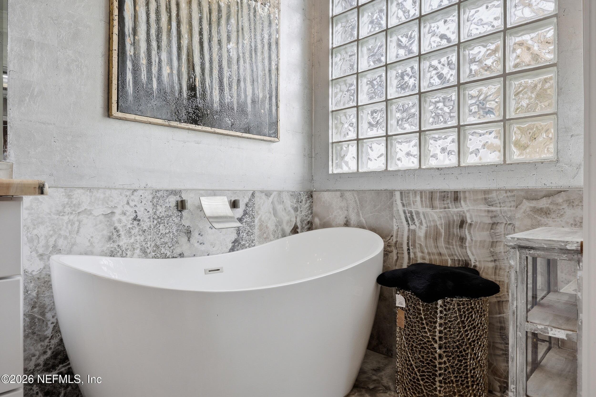 40 Tallwood Road Jacksonville Beach, FL 32250 - Photo 39 of 75 a white bath tub sitting in a bathroom next to a window
