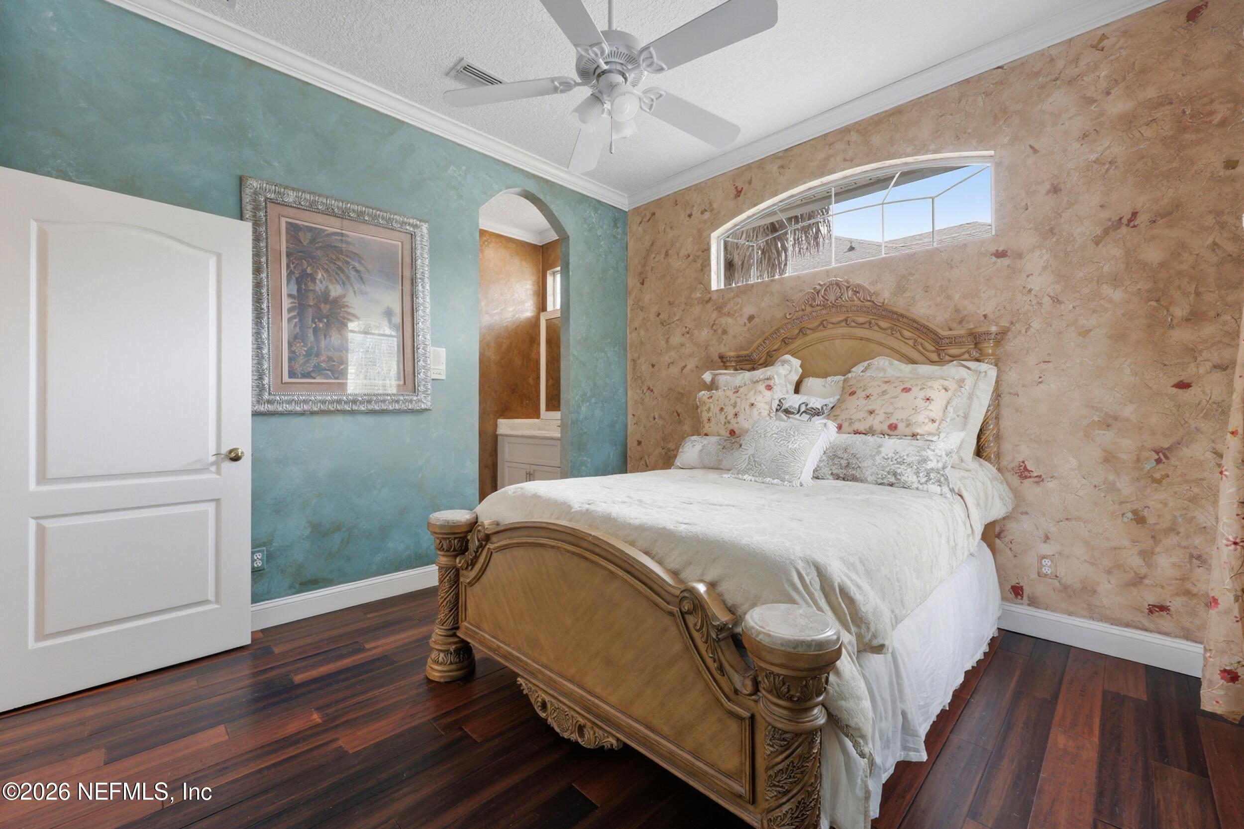 40 Tallwood Road Jacksonville Beach, FL 32250 - Photo 43 of 75 a bedroom with a bed and wooden floor