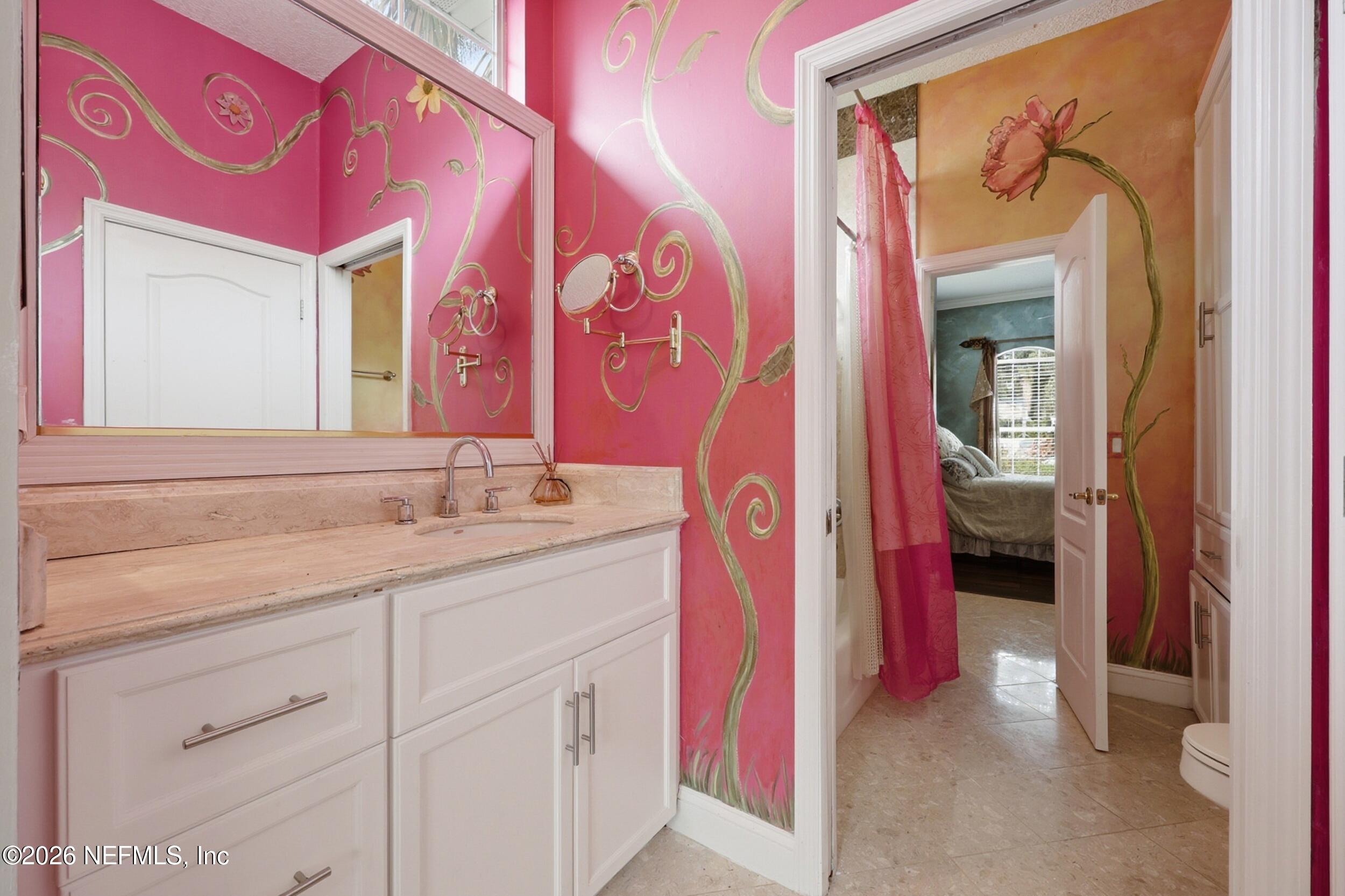 40 Tallwood Road Jacksonville Beach, FL 32250 - Photo 47 of 75 a en suite bathroom with a sink and a mirror