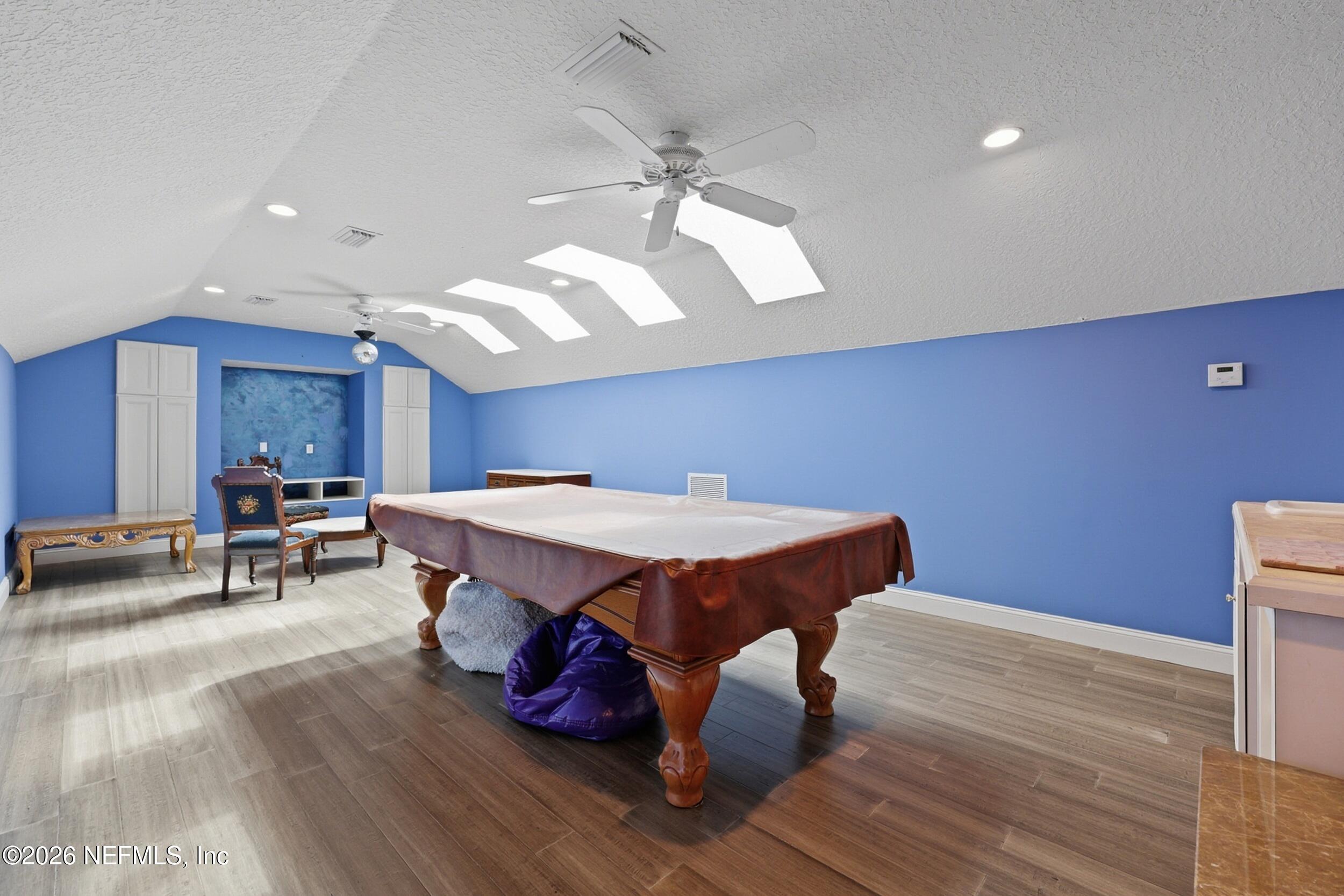 40 Tallwood Road Jacksonville Beach, FL 32250 - Photo 50 of 75 a dinning room with kitchen island stainless steel appliances wooden floor and chandelier