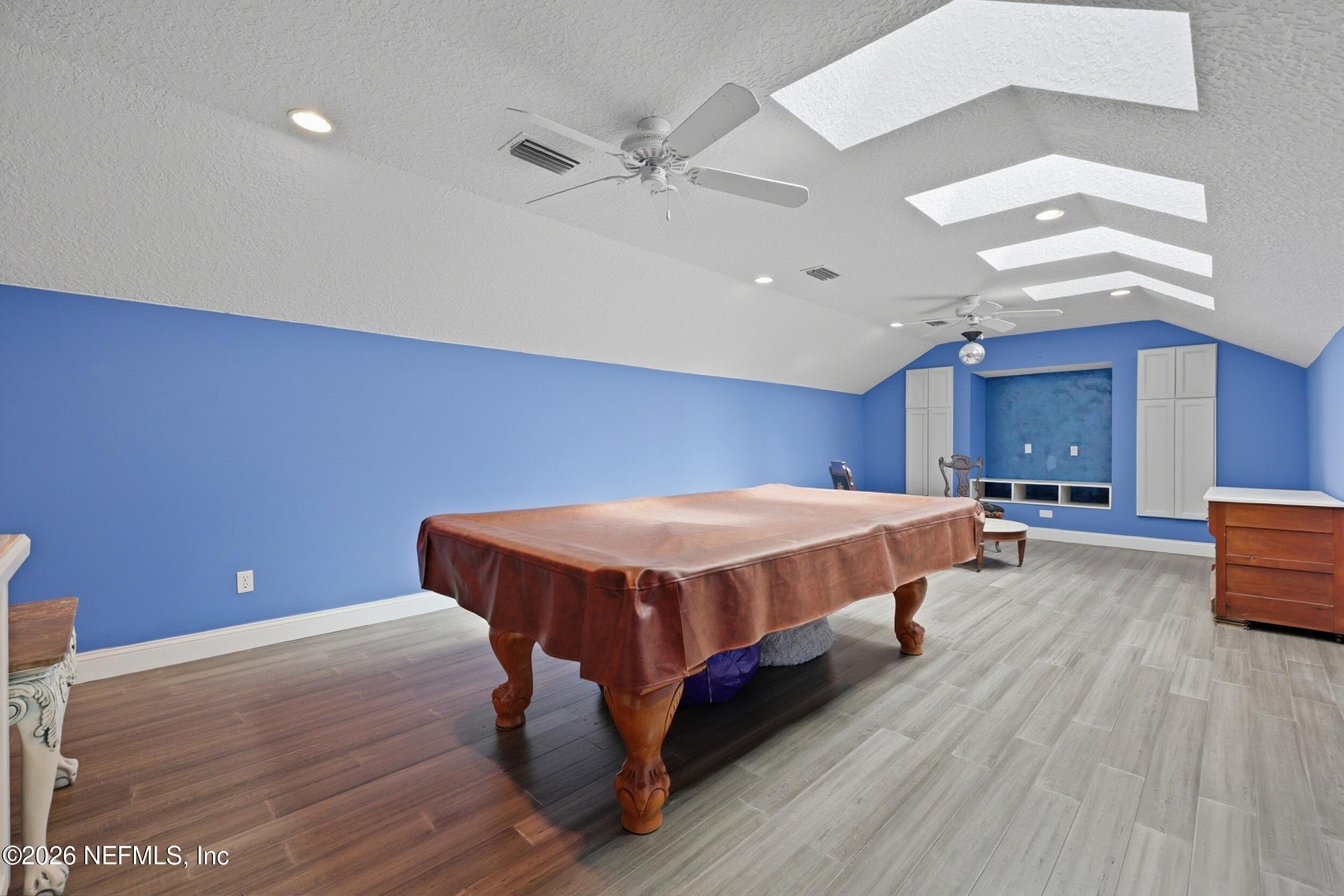 40 Tallwood Road Jacksonville Beach, FL 32250 - Photo 51 of 75 a spacious bedroom with a bed and a chandelier