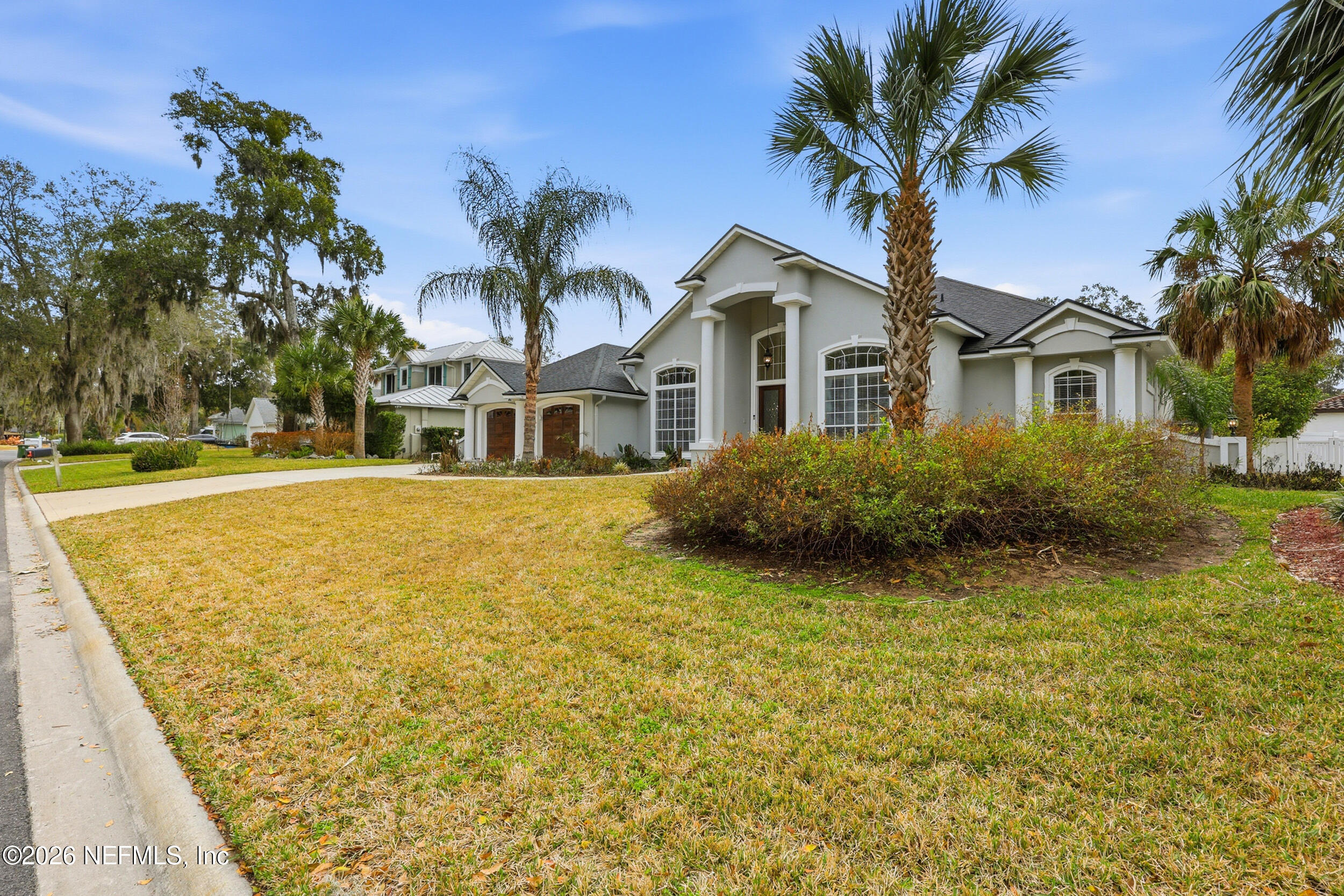 40 Tallwood Road Jacksonville Beach, FL 32250 - Photo 61 of 75 a front view of a house with a garden and trees