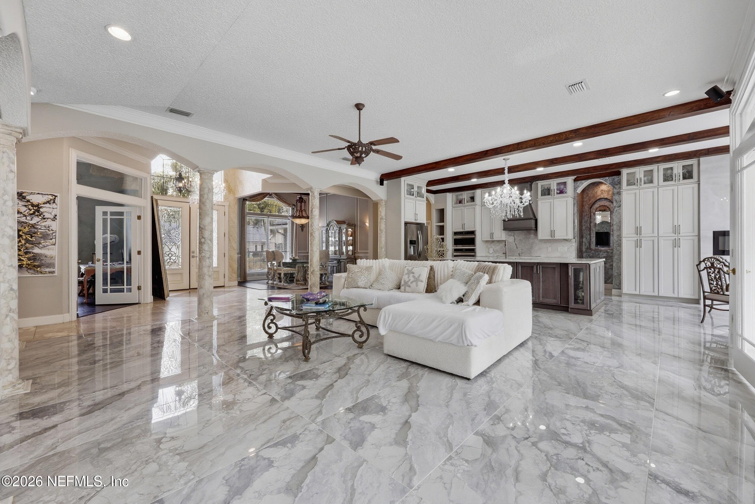 40 Tallwood Road Jacksonville Beach, FL 32250 - Photo 7 of 75 a living room with furniture and a chandelier