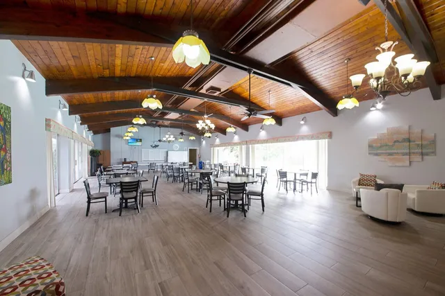 a front view of house with yard and lake view