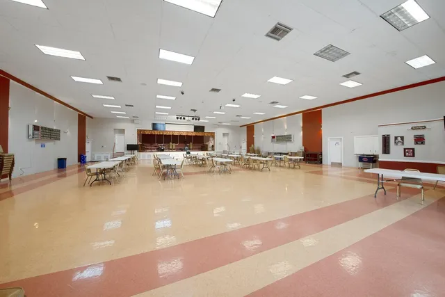 a kitchen with stainless steel appliances granite countertop a sink a stove and cabinets