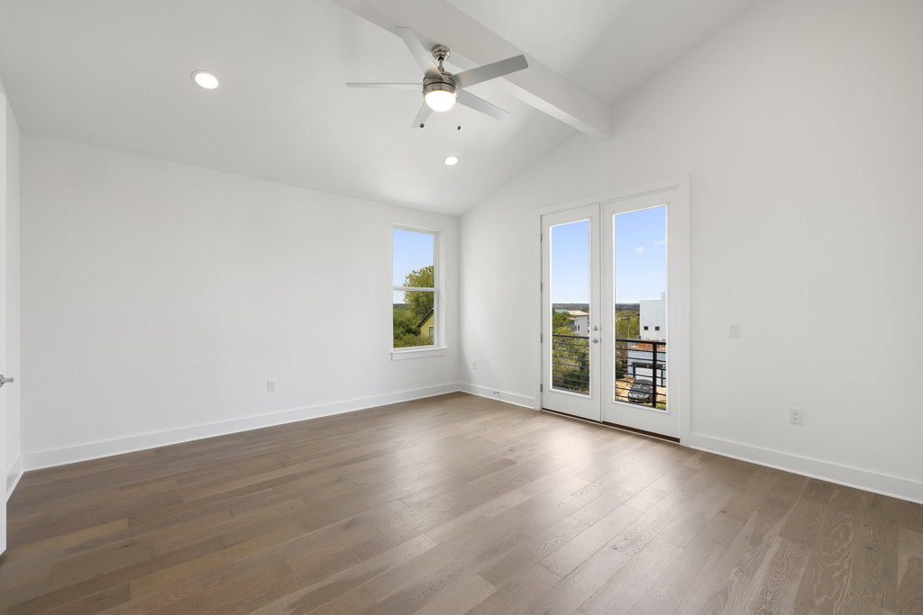 7321 Annette Cove Austin, TX 78724 - Photo 7 of 40 an empty room with wooden floor and windows