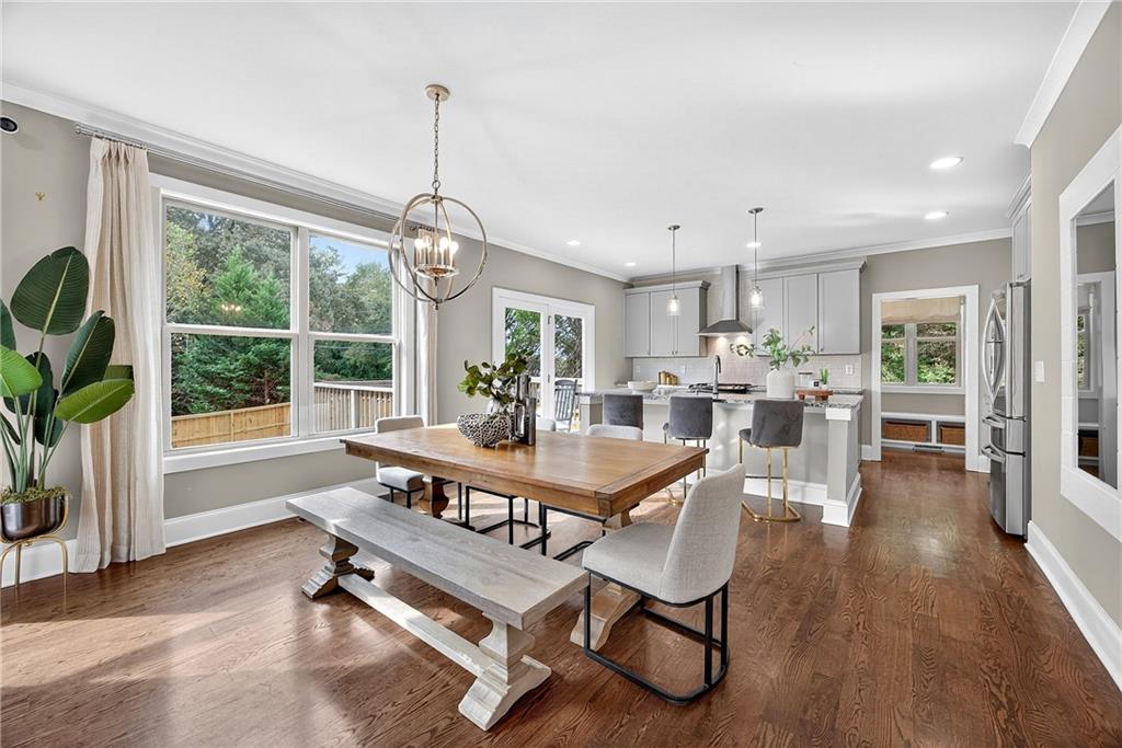 a dining room with furniture and wooden floor