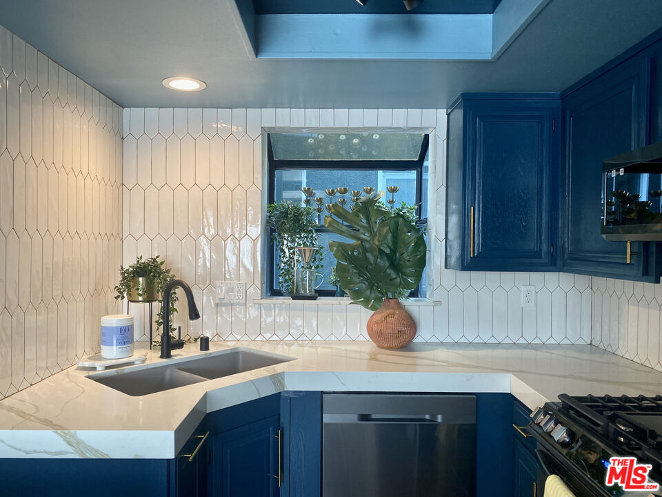 336 Highland Drive Oxnard, CA 93035 - Photo 16 of 25 a kitchen with sink a window and potted plant