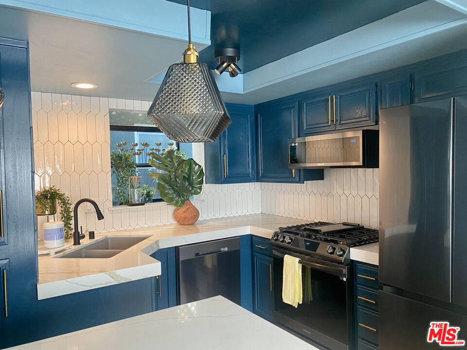 336 Highland Drive Oxnard, CA 93035 - Photo 17 of 25 a kitchen with stainless steel appliances granite countertop a sink stove and refrigerator