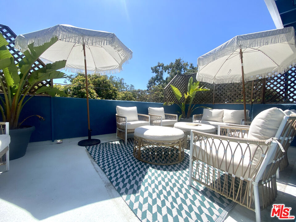 336 Highland Drive Oxnard, CA 93035 - Photo 9 of 25 a view of a patio with a table and chairs under an umbrella