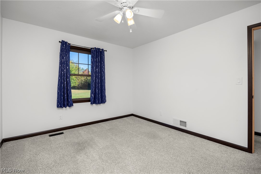 6760 Mason Road Berlin Heights, OH 44814 - Photo 20 of 49 Carpeted spare room with baseboards and a ceiling fan