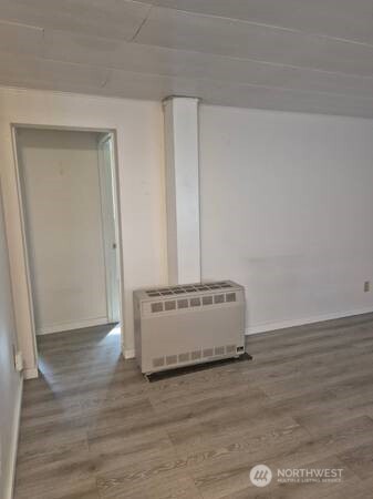 317 7th Street Southwest, Unit 3 Puyallup, WA 98371 - Photo 3 of 6 a view of a room with wooden floor and window
