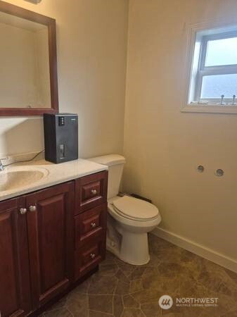 317 7th Street Southwest, Unit 3 Puyallup, WA 98371 - Photo 6 of 6 a bathroom with a sink a toilet and mirror