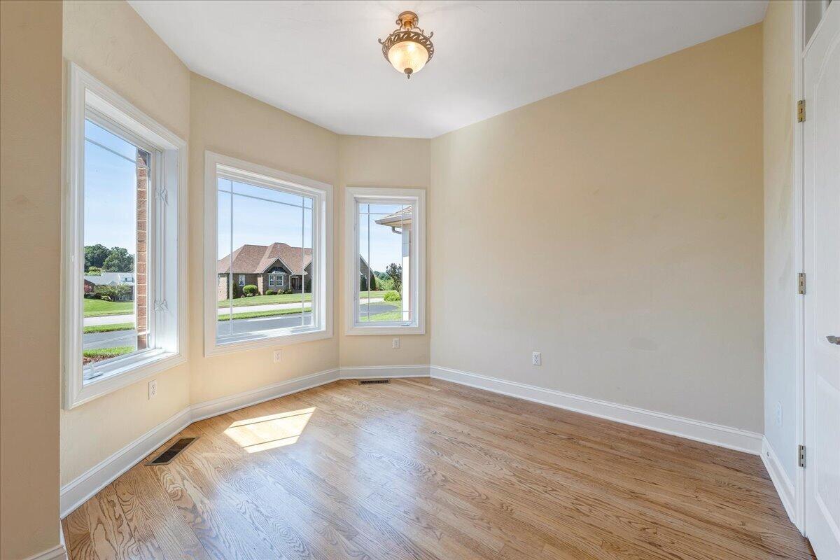 625 Frontier Way Fincastle, VA 24090 - Photo 33 of 105 a view of an empty room with wooden floor and a window