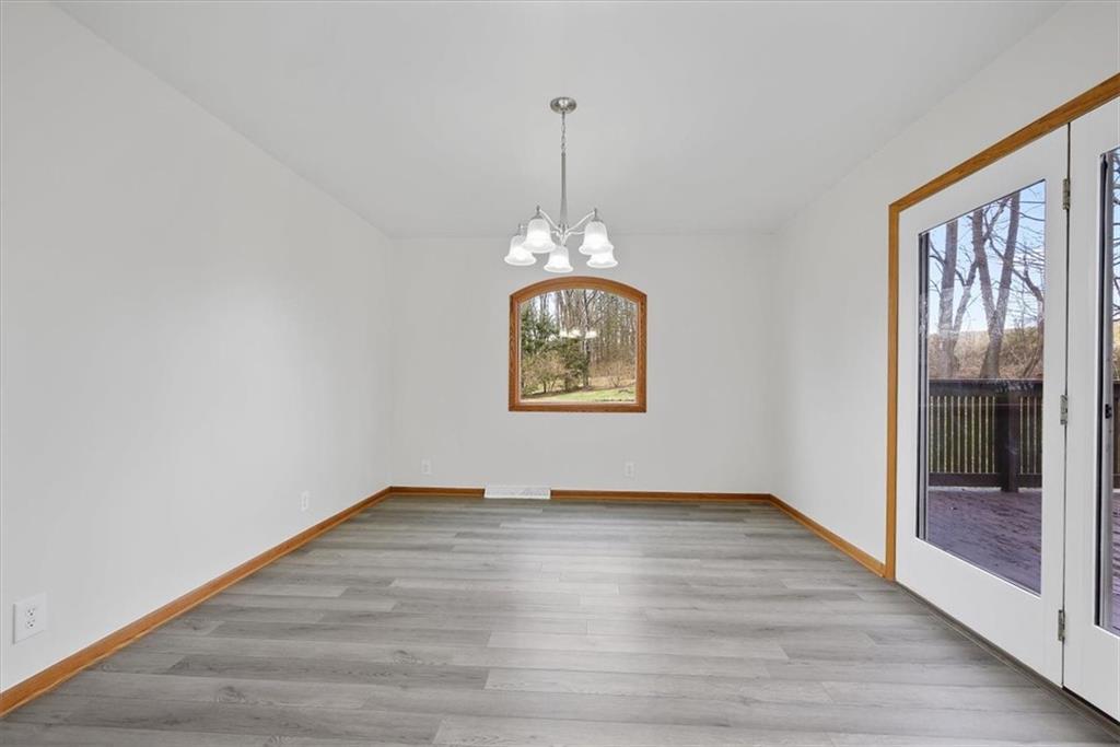 303 Chapin Road New Castle, PA 16105 - Photo 11 of 25 a view of an empty room with window and wooden floor