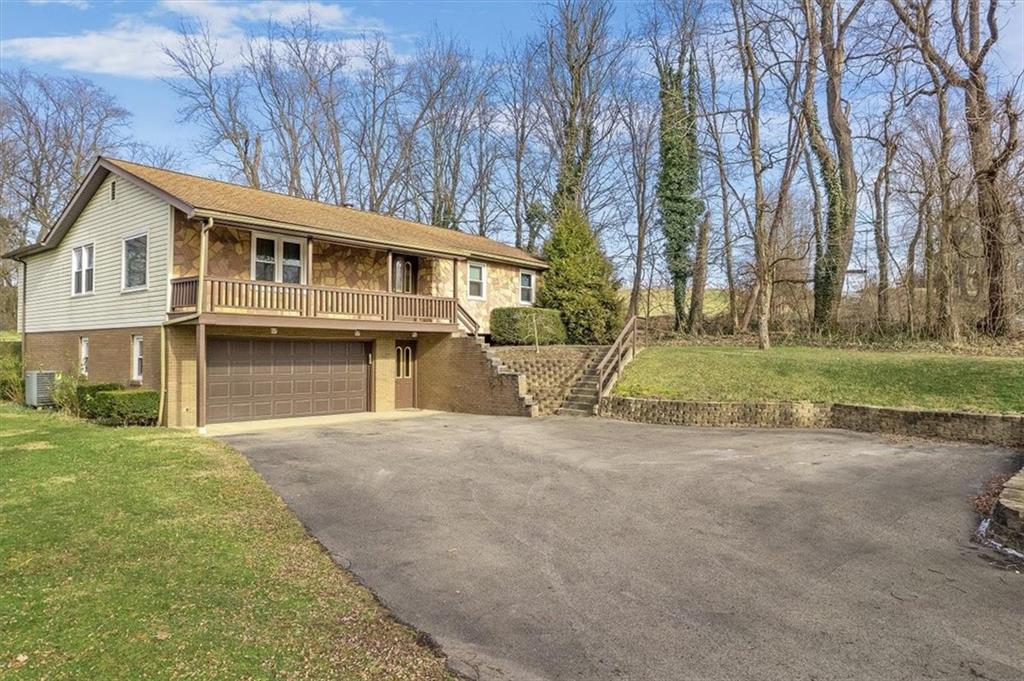 303 Chapin Road New Castle, PA 16105 - Photo 2 of 25 a front view of a house with a garden and trees