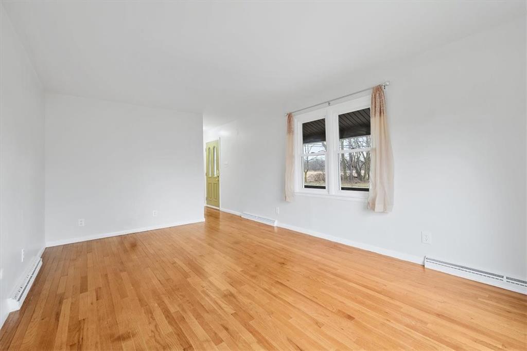 303 Chapin Road New Castle, PA 16105 - Photo 5 of 25 a view of an empty room with wooden floor and a window