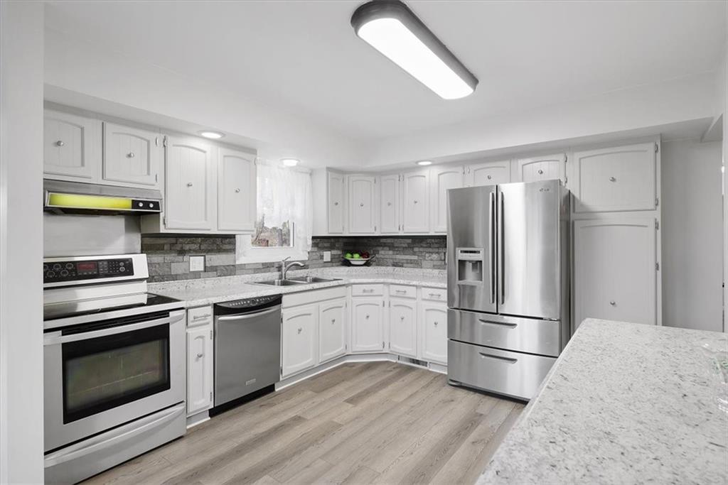 303 Chapin Road New Castle, PA 16105 - Photo 8 of 25 a kitchen with a refrigerator stove and wooden cabinets
