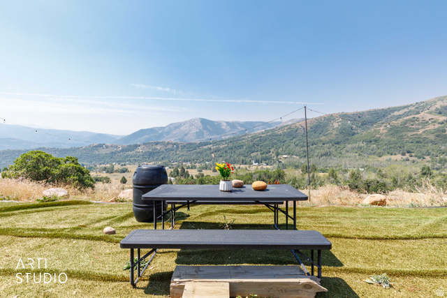 3190 Spring Way, Unit 417 Huntsville, UT 84317 - Photo 6 of 33 Expansive outdoor area with a mountain backdrop, featuring a manicured lawn and a black outdoor dining set