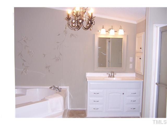 2559 Smith Road Oxford, NC 27565 - Photo 22 of 25 Master bath is tastefully remodelled with a charming chandelier, separate vanities, a stall shower and a Jacuzzi garden tub. Master Bath/Spa
