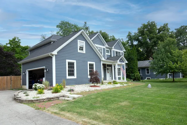 a front view of house with yard and green space