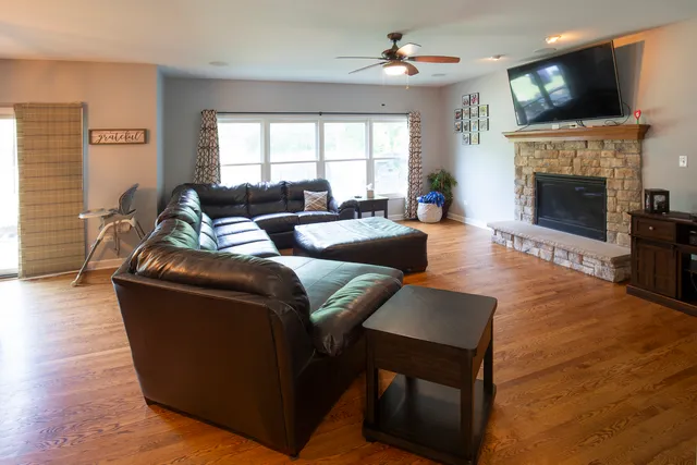 a living room with furniture a flat screen tv and a fireplace