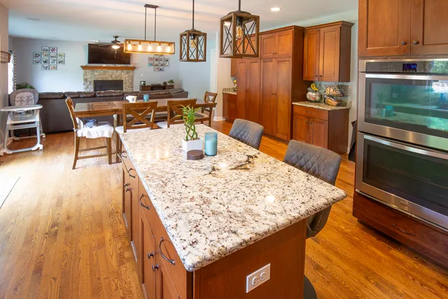 a dining table with chairs and kitchen view