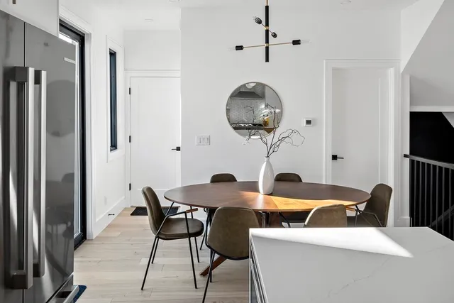 a view of a room that has a dining table and chairs