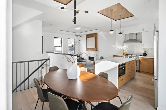 a large white kitchen with a table and chairs