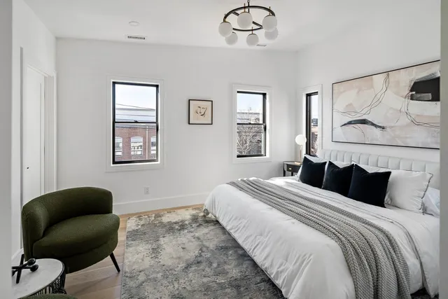 a bathroom with a double vanity sink toilet mirror and bathtub