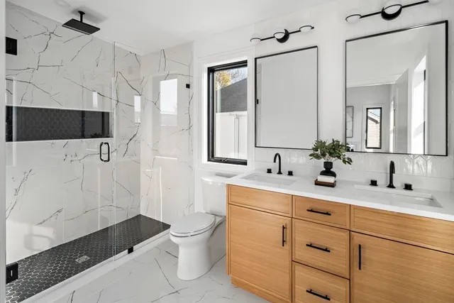 a bathroom with a sink vanity mirror and toilet