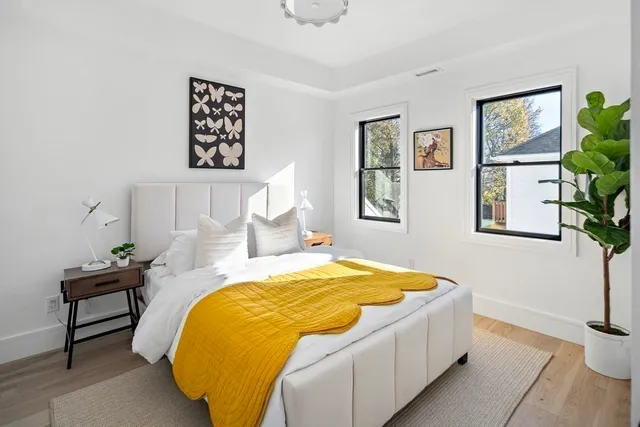 a bedroom with a bed and painting on the wall