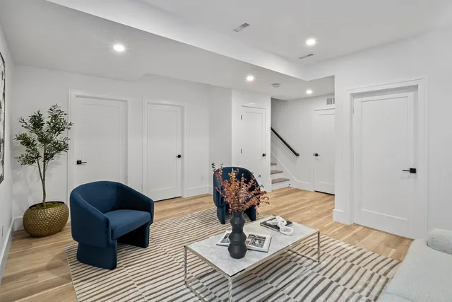 a living room with furniture and a wooden floor
