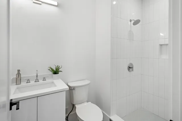 a bathroom with a toilet sink and shower