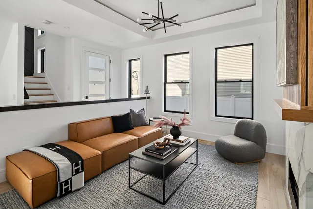 a living room with furniture a rug and a window
