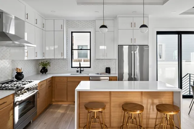 a kitchen with stainless steel appliances granite countertop a kitchen island hardwood floor sink stove and refrigerator