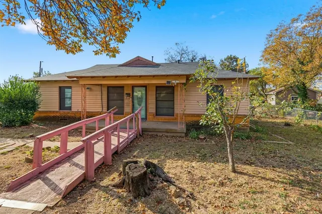 a view of a house with a wooden fence