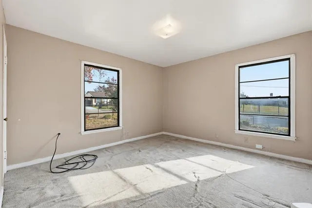 an empty room with a empty space and windows