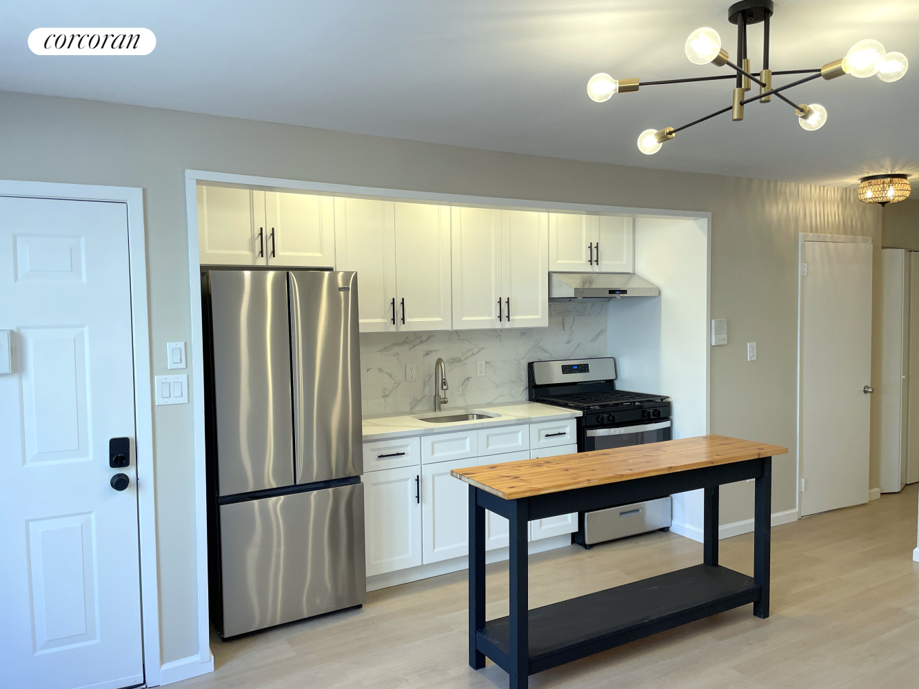 a kitchen with stainless steel appliances a refrigerator a sink dishwasher a stove and a refrigerator