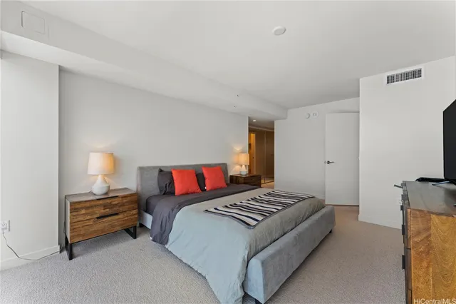 a bedroom with a bed and a lamp