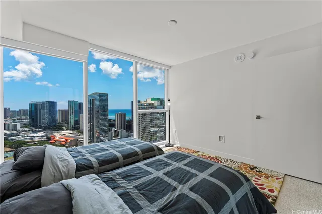 a bedroom with a bed couch and a night stand