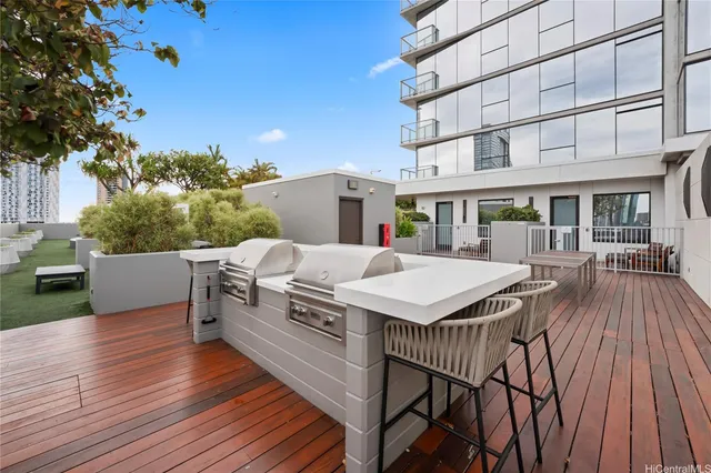 a view of a patio with table and chairs with wooden floor and fence