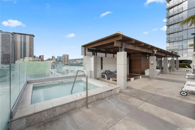 a view of a terrace with chairs and barbeque with wooden fence