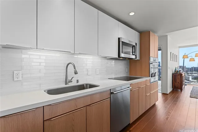 a kitchen with a sink cabinets and wooden floor