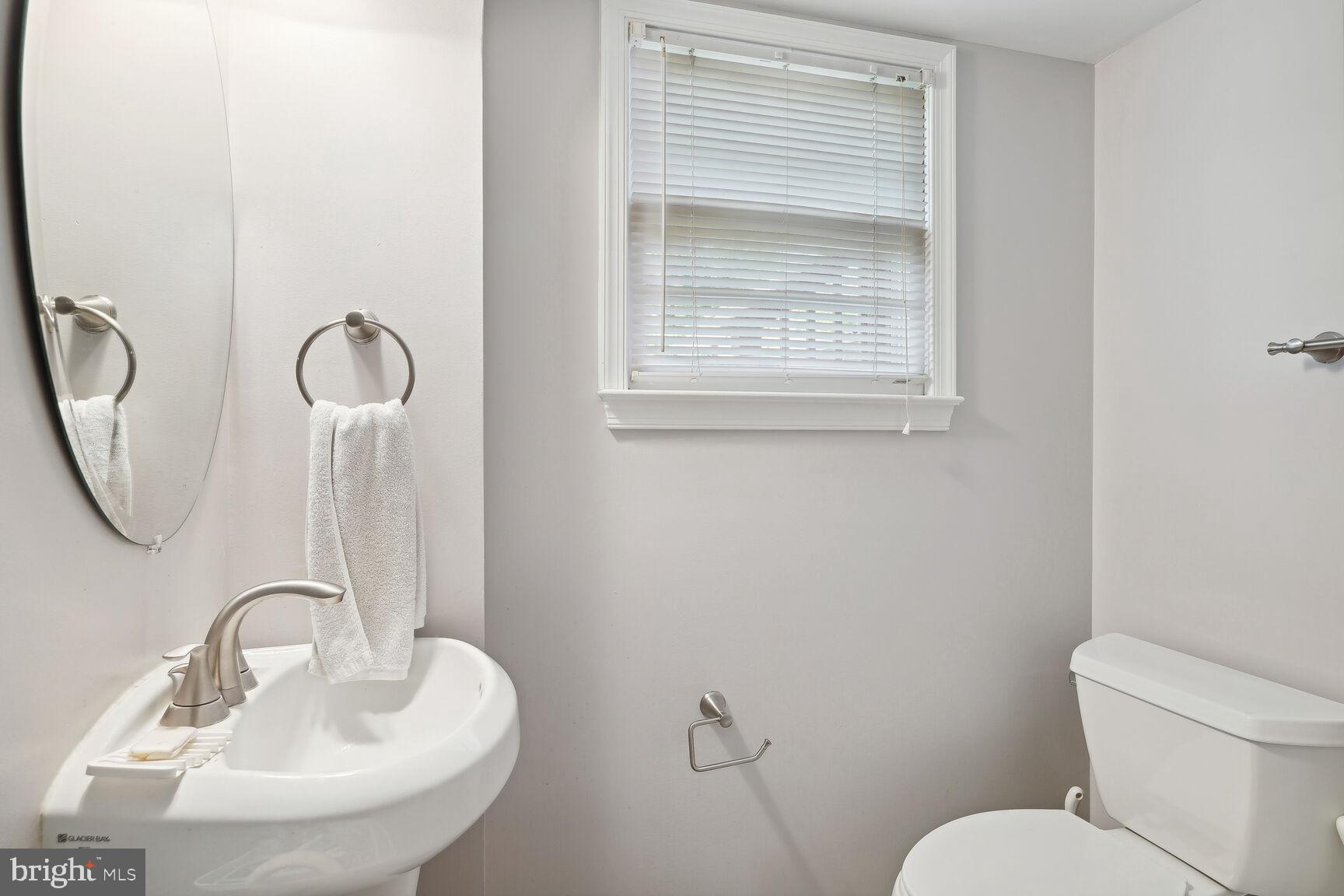 7011 Hector Road McLean, VA 22101 - Photo 16 of 20 a bathroom with a toilet sink and mirror